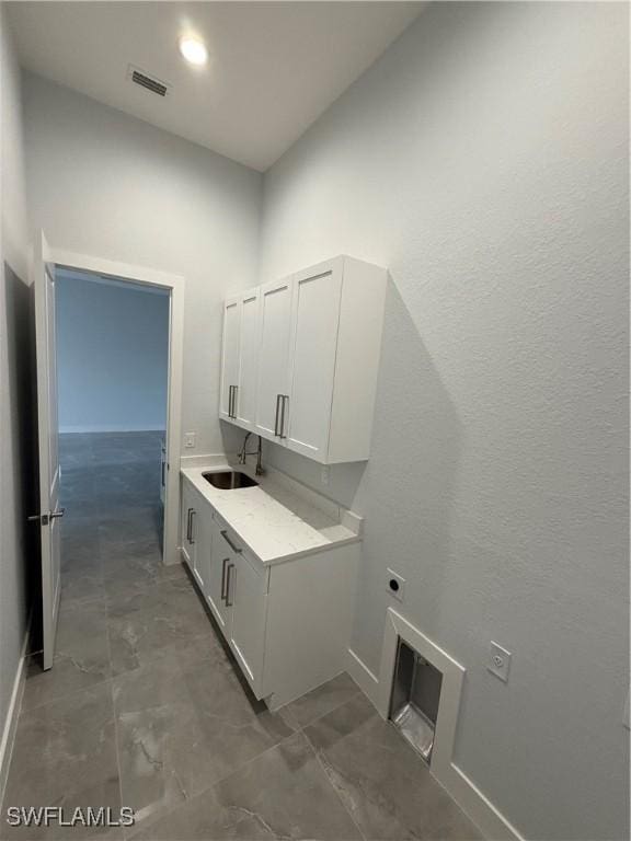 laundry room with hookup for an electric dryer and sink