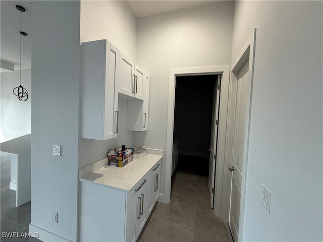 kitchen with white cabinets and light stone counters