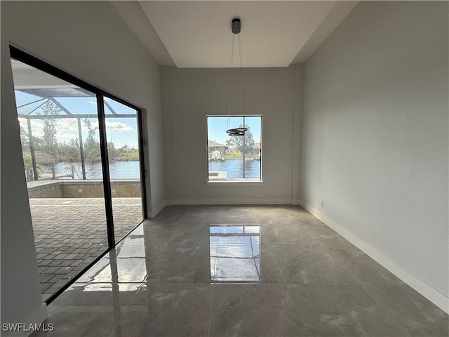 unfurnished dining area with a water view