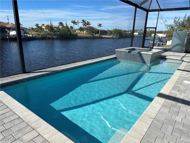 view of pool featuring an in ground hot tub, a water view, and glass enclosure