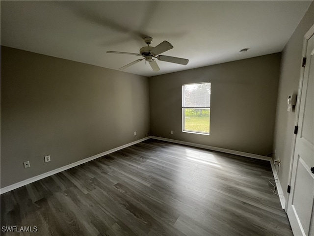 spare room featuring ceiling fan and dark hardwood / wood-style flooring