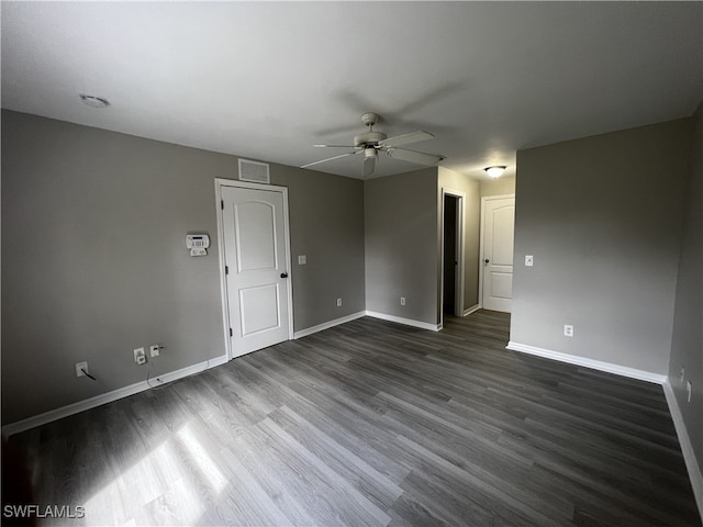 empty room with dark wood-type flooring and ceiling fan