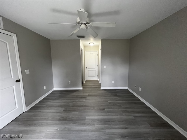 unfurnished room with ceiling fan and dark hardwood / wood-style floors