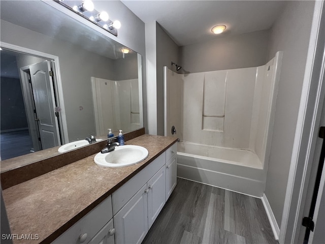 bathroom featuring hardwood / wood-style floors, shower / tub combination, and vanity