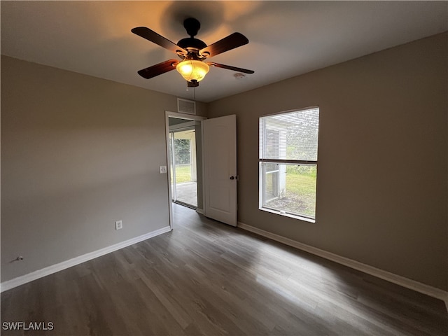 spare room with ceiling fan, hardwood / wood-style flooring, and a healthy amount of sunlight