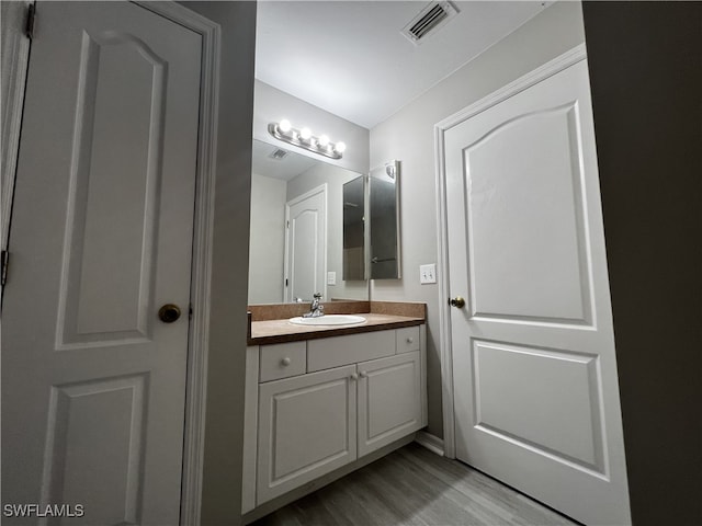 bathroom featuring hardwood / wood-style floors and vanity