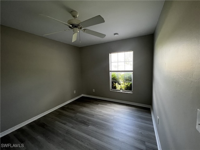 spare room featuring ceiling fan and dark hardwood / wood-style floors