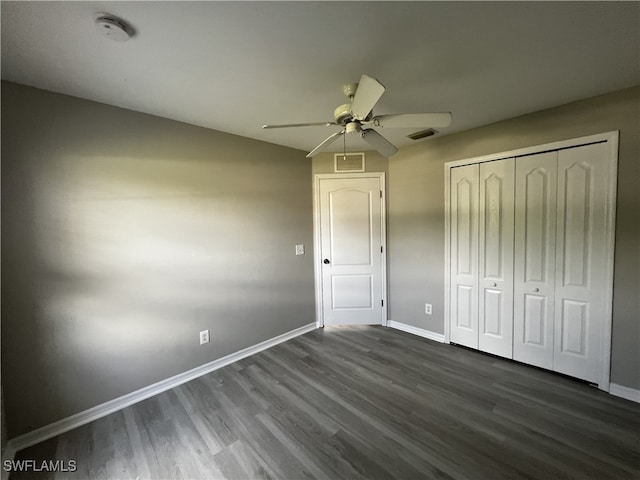 unfurnished bedroom with a closet, ceiling fan, and dark hardwood / wood-style floors