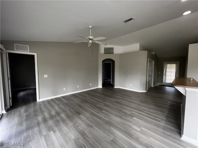 unfurnished living room featuring hardwood / wood-style floors, ceiling fan, and vaulted ceiling