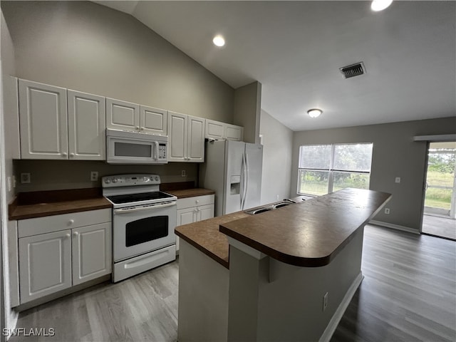 kitchen with white cabinets, white appliances, sink, and light wood-type flooring