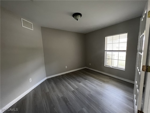 spare room featuring dark hardwood / wood-style floors