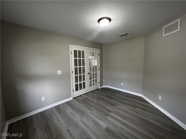 unfurnished room with dark wood-type flooring and french doors