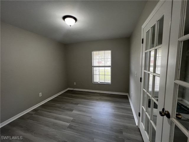 unfurnished room featuring dark wood-type flooring