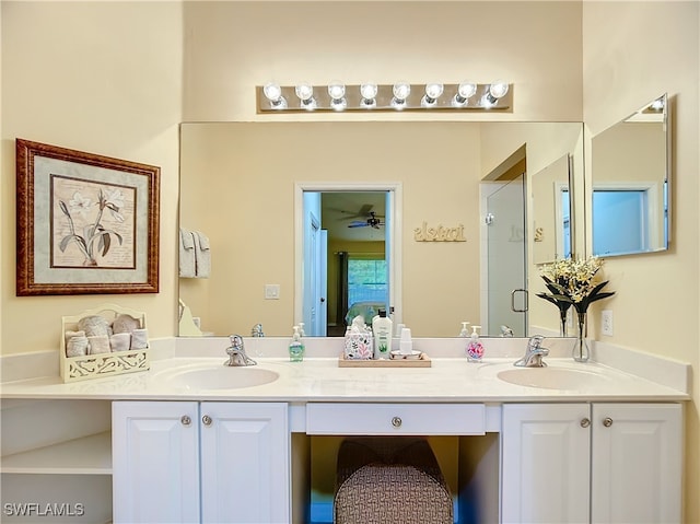 bathroom with vanity, ceiling fan, and a shower with shower door