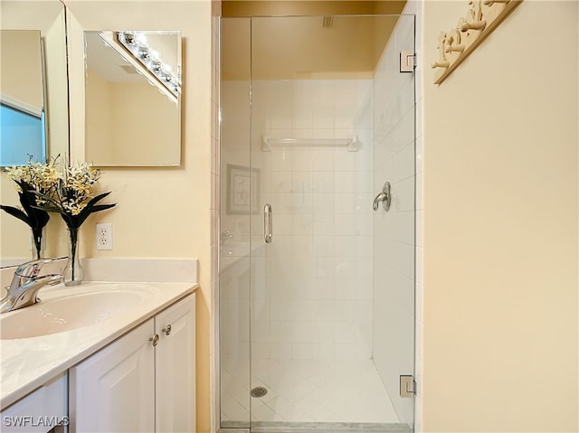 bathroom featuring vanity and an enclosed shower