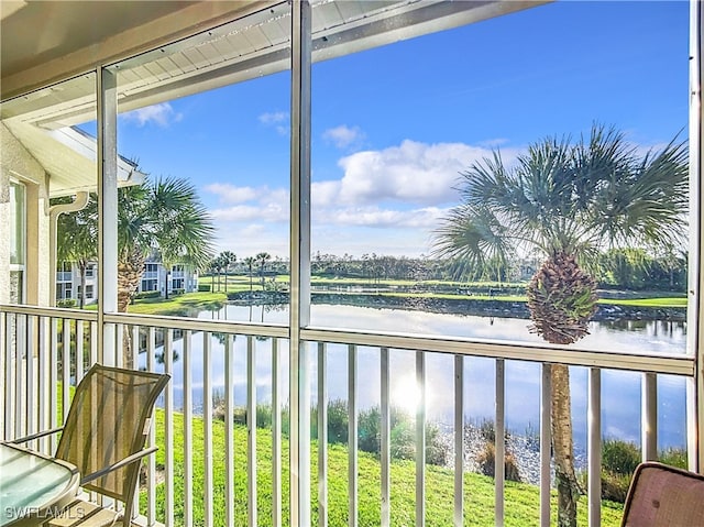 unfurnished sunroom featuring a water view and a wealth of natural light