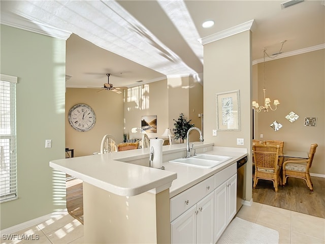 kitchen featuring white cabinets, light hardwood / wood-style floors, ornamental molding, and sink