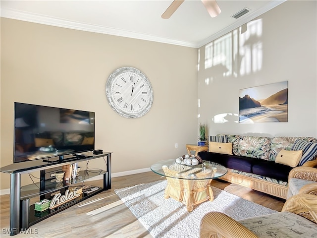 living room featuring crown molding, ceiling fan, and wood-type flooring