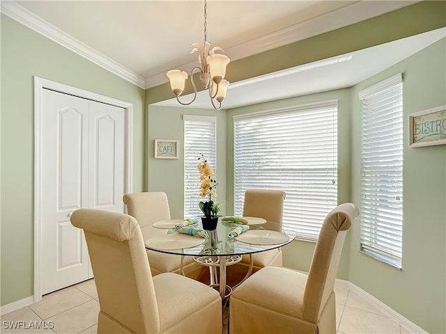 tiled dining space with ornamental molding and a chandelier