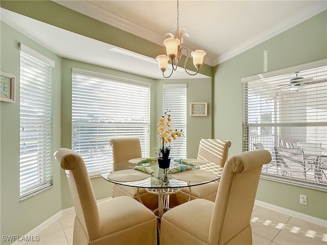 tiled dining room featuring a chandelier, a healthy amount of sunlight, and ornamental molding