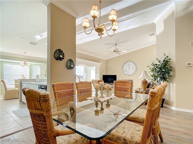 dining space featuring ornamental molding, ceiling fan with notable chandelier, and light wood-type flooring