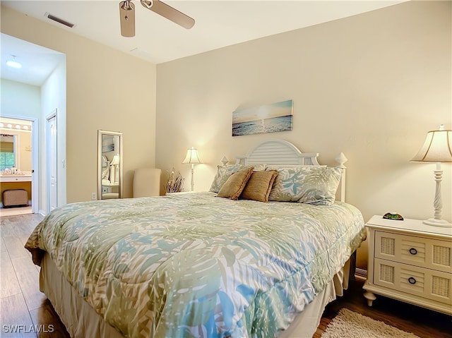 bedroom featuring hardwood / wood-style floors, ceiling fan, a closet, and ensuite bath