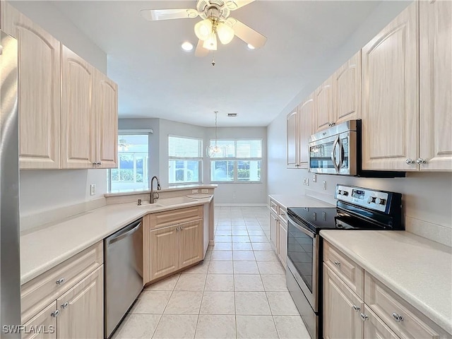 20752 Mystic Way N, Fort Myers, FL 33917 - kitchen featuring stainless steel appliances, a ceiling fan, light tile patterned floors, light countertops, and a peninsula