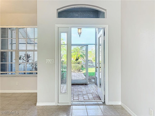 doorway with light tile patterned floors