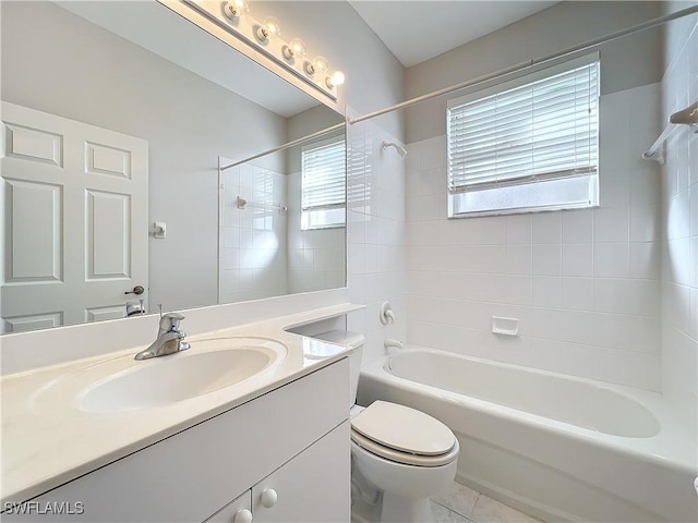 full bathroom featuring tile patterned flooring, vanity, toilet, and tiled shower / bath