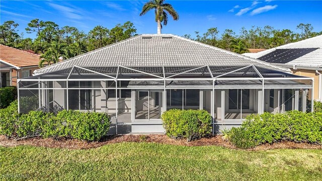 20752 Mystic Way N, Fort Myers, FL 33917 - rear view of property featuring a lawn, a lanai, and a tile roof
