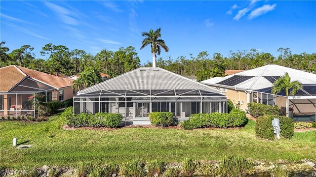 20752 Mystic Way N, Fort Myers, FL 33917 - back of house featuring a lawn and glass enclosure