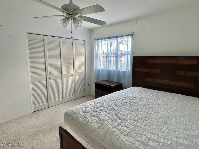 bedroom with light carpet, a closet, and ceiling fan