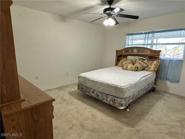 bedroom with light carpet and ceiling fan