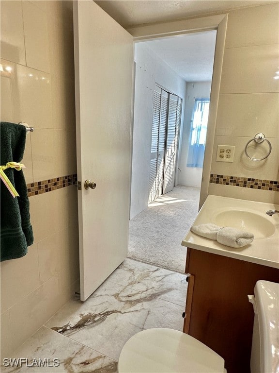 2828 Jackson St Unit F-7, Fort Myers, FL 33901 - bathroom with vanity, toilet, and marble look tiles