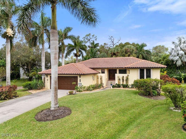 mediterranean / spanish-style home with a garage and a front yard