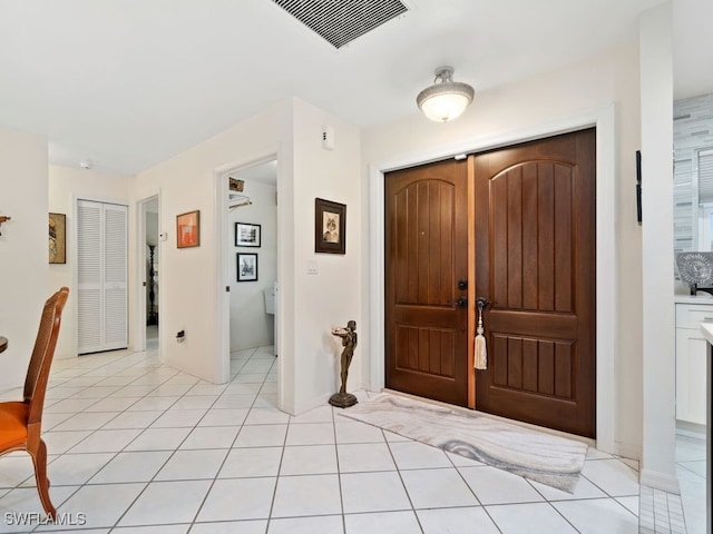 entryway with light tile patterned floors