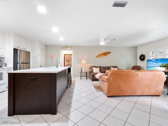 tiled living room with sink and ceiling fan