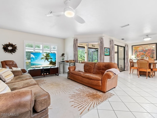 living room featuring light tile patterned floors and ceiling fan