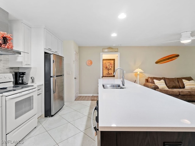 kitchen with white cabinetry, stainless steel refrigerator, light tile patterned floors, sink, and electric range