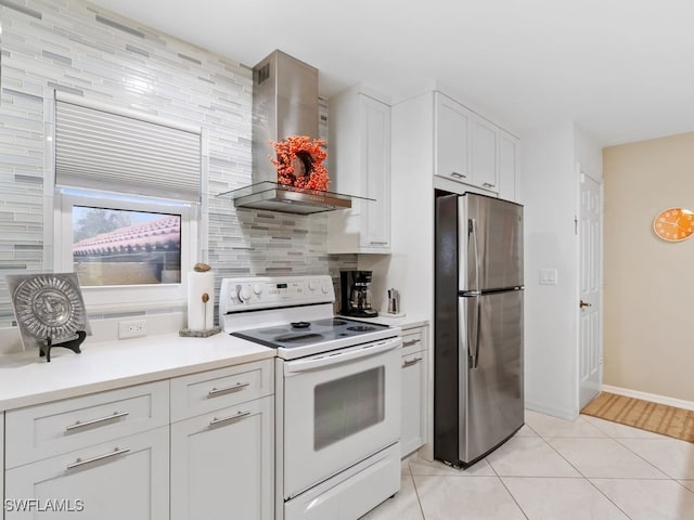 kitchen with electric stove, wall chimney exhaust hood, backsplash, white cabinetry, and stainless steel fridge