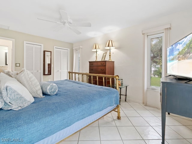 bedroom with multiple closets, ceiling fan, and light tile patterned flooring