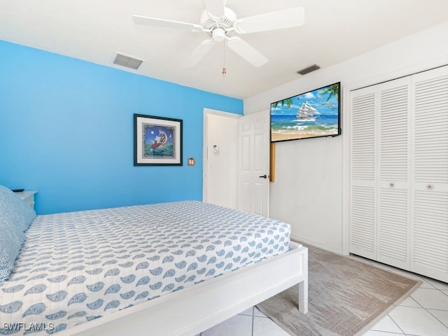 tiled bedroom with a closet and ceiling fan