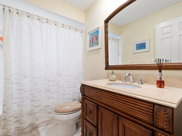 bathroom featuring toilet, vanity, and tile patterned flooring