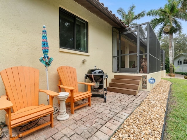 view of patio featuring a lanai