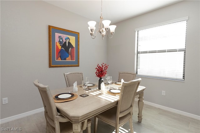 dining room featuring light wood-type flooring and a chandelier