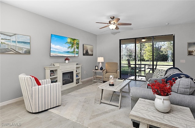 living room with ceiling fan and light hardwood / wood-style floors