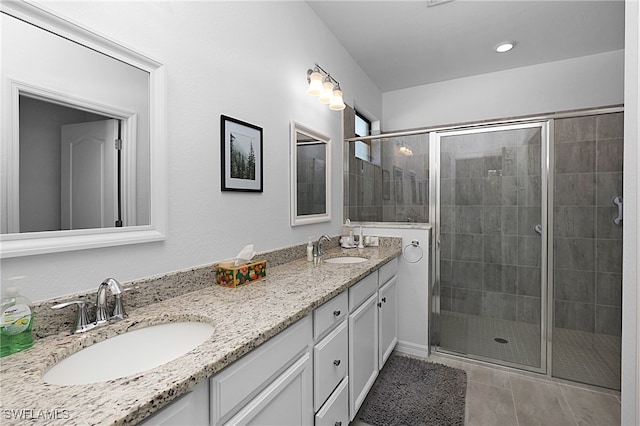 bathroom featuring walk in shower, vanity, and tile patterned floors