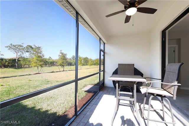 sunroom featuring ceiling fan