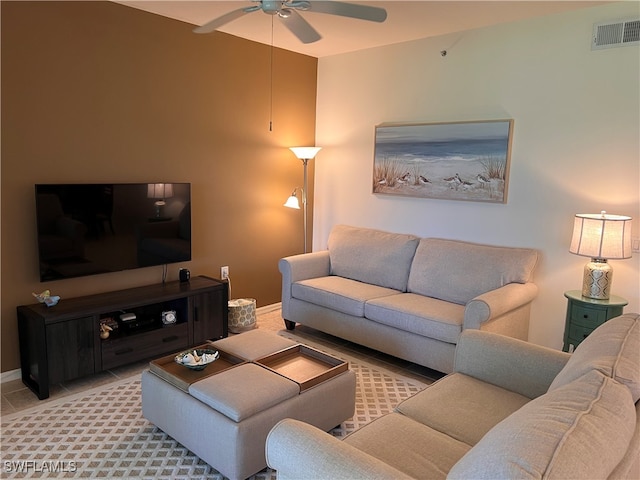 living room with tile patterned flooring and ceiling fan