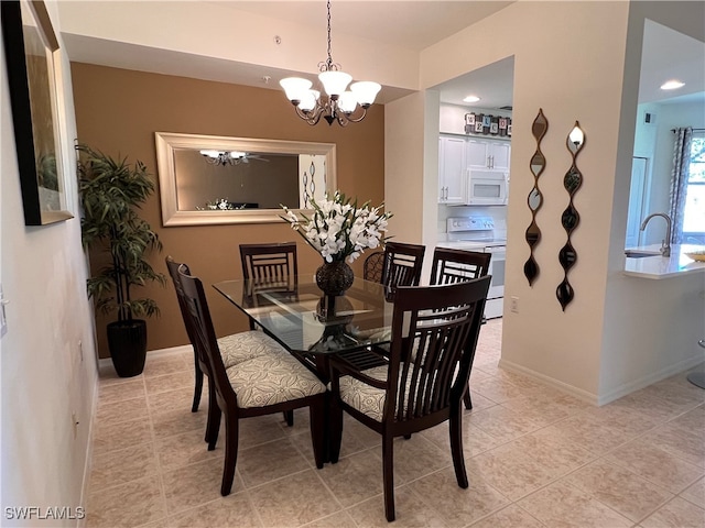 dining area with a chandelier, light tile patterned floors, and sink